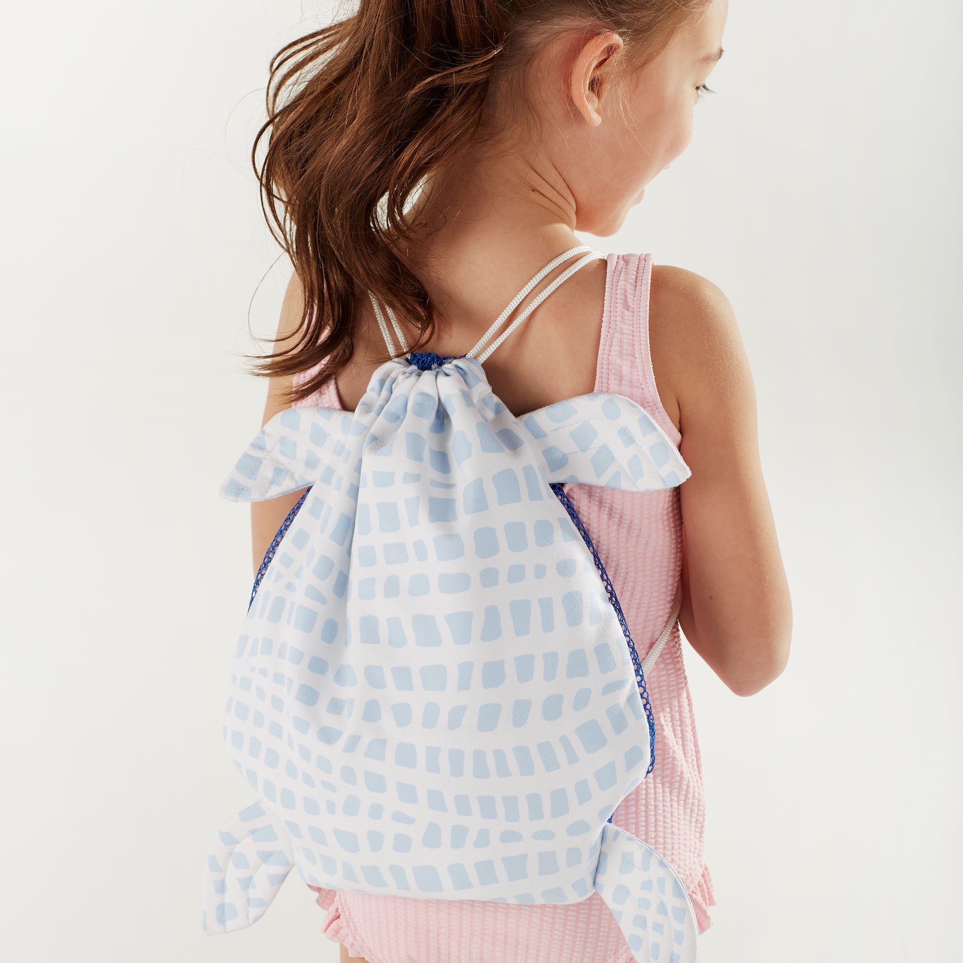 Norwex Kids Hooded Beach Towel - girl wearing Sea Turtle drawstring bag as backpack