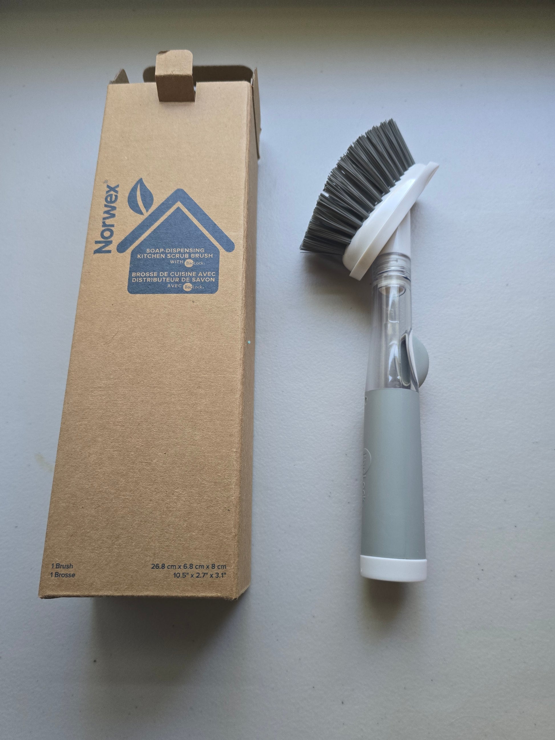 Norwex Soap-Dispensing Kitchen Scrub Brush - product next to Norwex box packaging