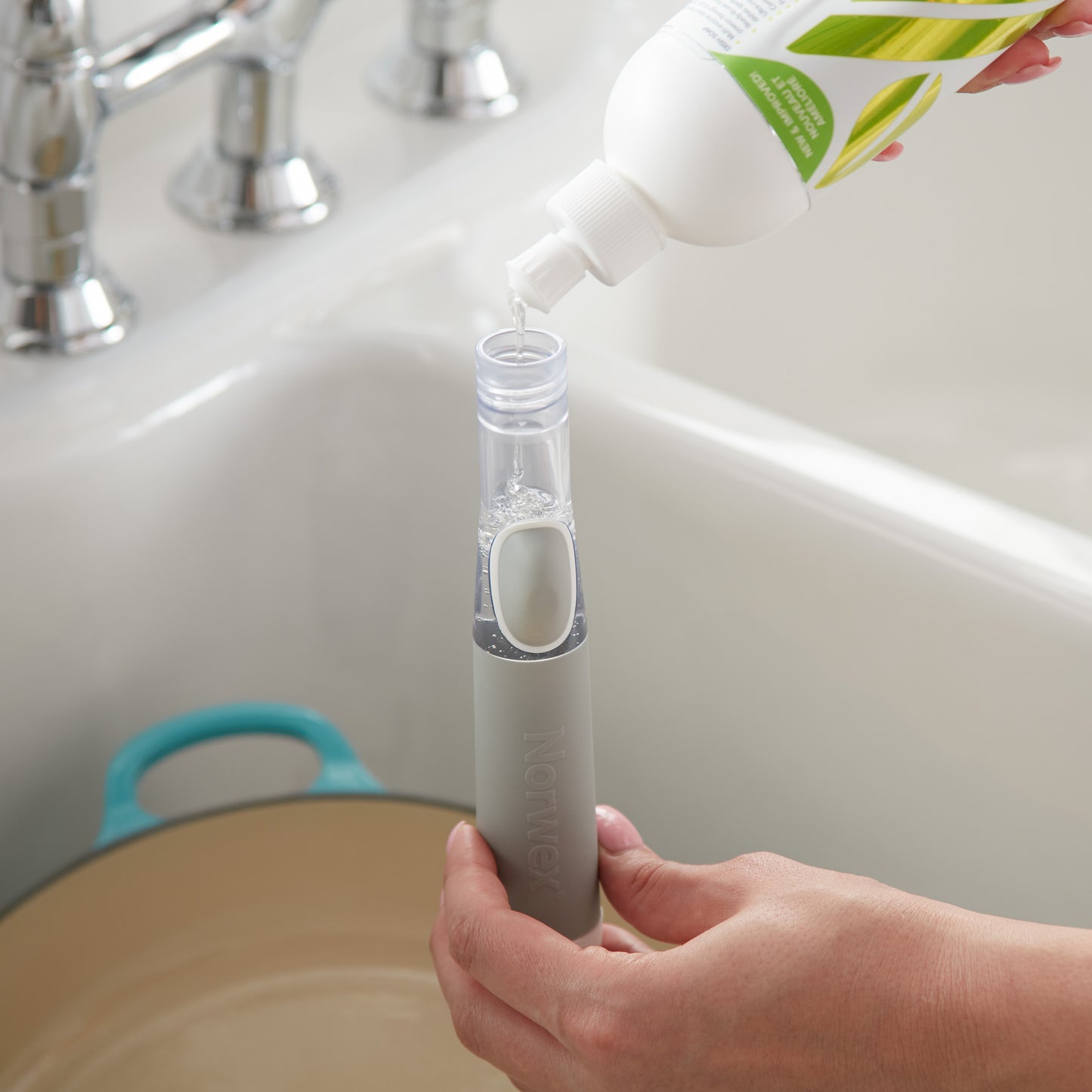 Norwex Soap-Dispensing Kitchen Scrub Brush - filling soap reservoir from dish soap bottle
