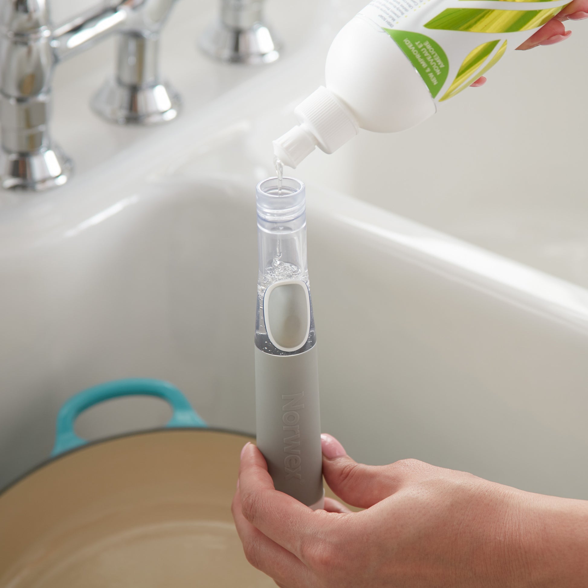 Norwex Soap-Dispensing Kitchen Scrub Brush - filling soap reservoir from dish soap bottle